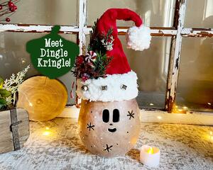 This is a whimsical Christmas elf made with a real dried gourd. This elf's name is Dingle. His face is carved into the round gourd shell. 